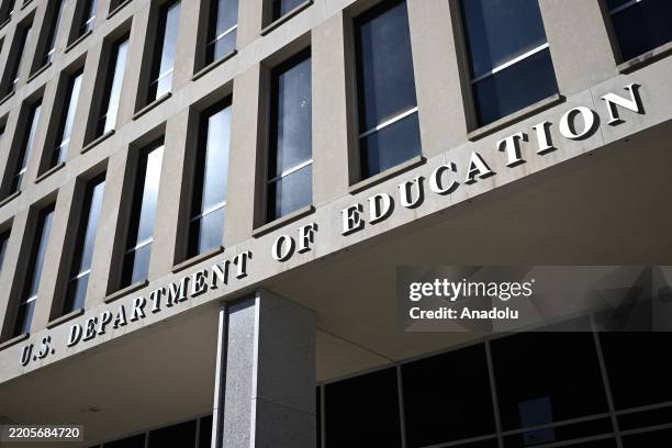 People gather to protest against US President Donald Trump and his senior advisor Elon Musk after Trump has signed a presidential decree to abolish...