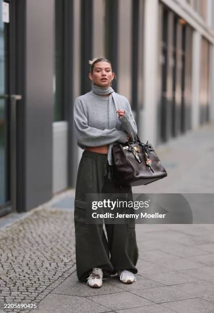 Sophia Geiss seen wearing Meotine light grey cropped wool sweater with a Meotine mini scarf detail wrapped around the neck, The Frankie Shop...