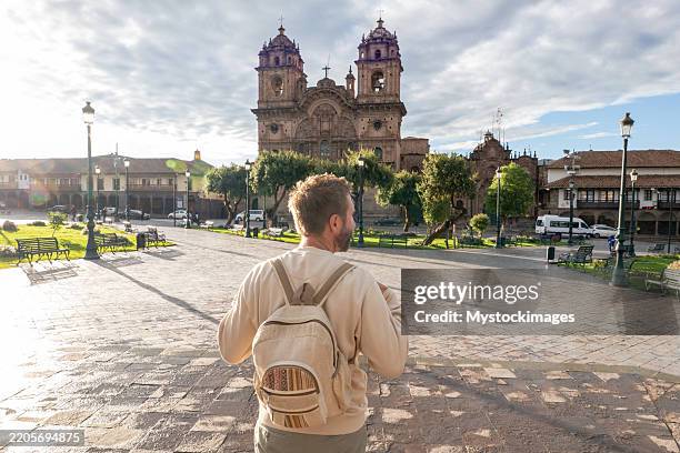 tourist admiring colonial architecture in historic plaza - adulation stock pictures, royalty-free photos & images