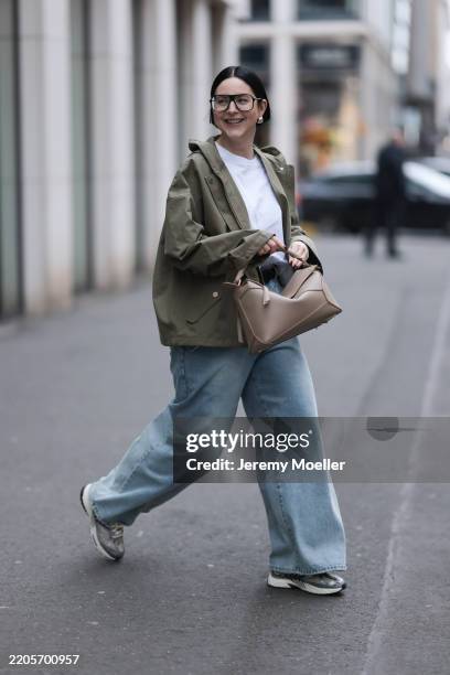 Maria Barteczko seen wearing Victoria Beckham black oversized aviator eyewear glasses, COS white basic cotton shirt, g-lab olive green hooded...