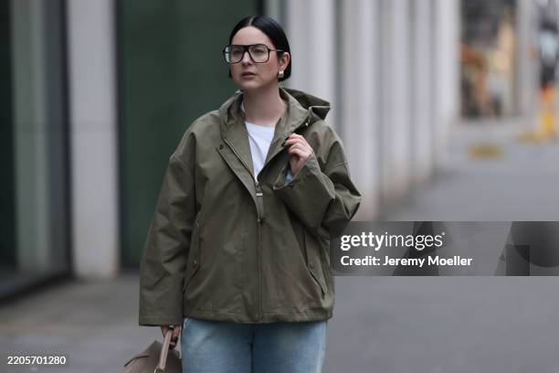 Maria Barteczko seen wearing Victoria Beckham black oversized aviator eyewear glasses, COS white basic cotton shirt, g-lab olive green hooded...