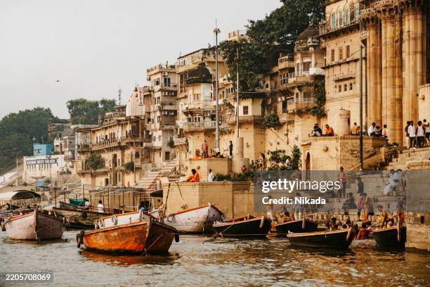 varanasi holy city along the ganges river with religious temples and boats - ganges river stock pictures, royalty-free photos & images