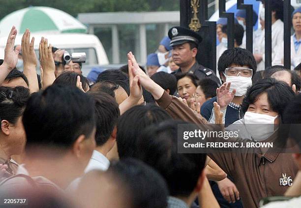 Recovered Severe Acute Respiratory Syndrome patient high-fives well wishers upon her release from the Xiaotangshan SARS Hospital on the rural...