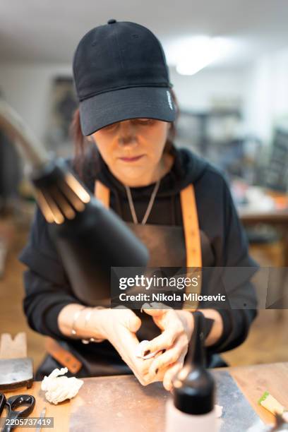 craftsperson focused on ceramic sculpting in a creative workshop - persistence stock pictures, royalty-free photos & images