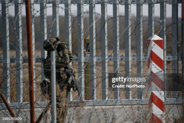 Soldier of the Polish Border Guard uses a binocular as he stays guard before the Prime Minister's visit on the Polish-Belarusian border in Ozierany...