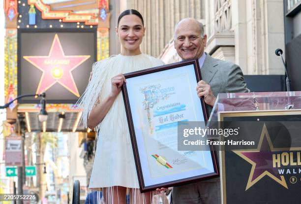 Gal Gadot and Steven Nissen, President & CEO, Hollywood Chamber of Commerce pose onstage during the ceremony honoring Gal Gadot with a Star on the...