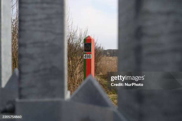 Border post of the Republic of Belarus is pictured behind a fence at the Polish-Belarusian border in Ozierany Male, Poland on March 22, 2025. The...