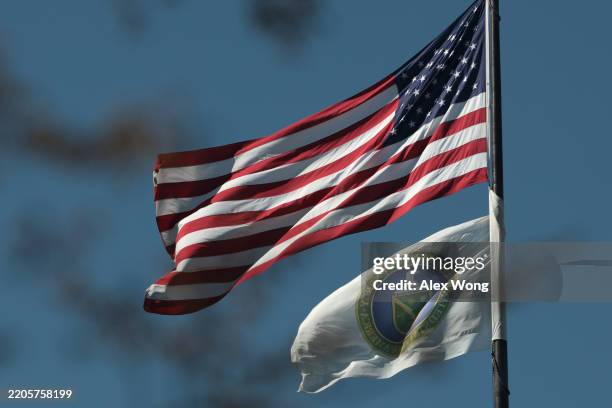 Flag and the flag of the U.S. Department of Energy fly outside its building on March 18, 2025 in Washington, DC. The Trump administration announced...