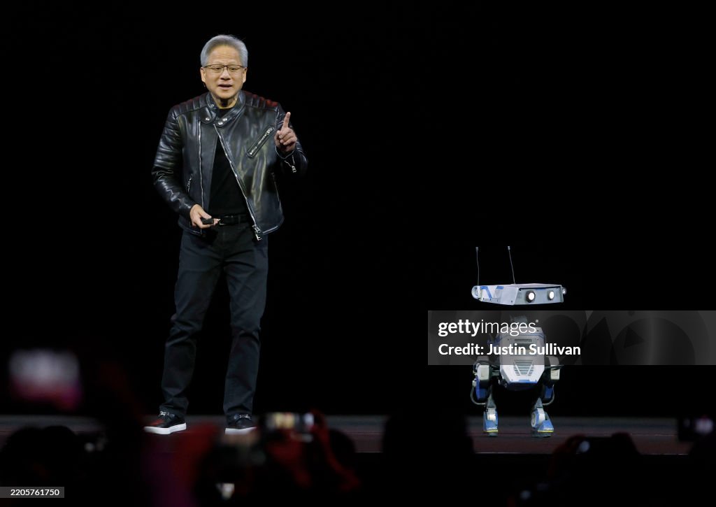 Jensen Invidia Nvidia CEO Jensen Huang delivers the keynote address with a robot ...