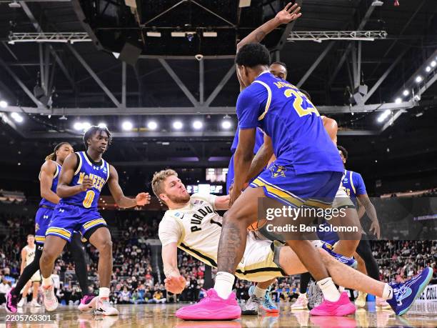 Caleb Furst of the Purdue Boilermakers an dBrandon Murray of the McNeese Cowboys battle for the ball during the second round of the 2025 NCAA Men's...
