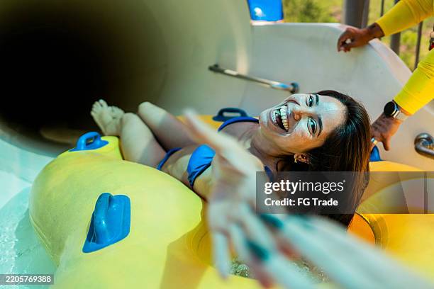 portrait of a young woman on a water park slide - water park stock pictures, royalty-free photos & images