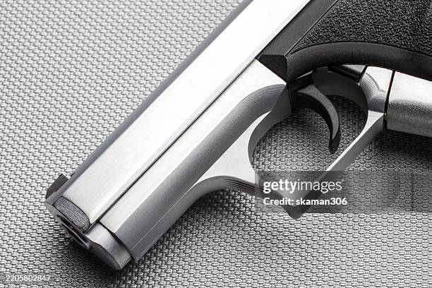 close up handgun and gun barrel on white background isolate - revolver-with-silencer stock-fotos und bilder