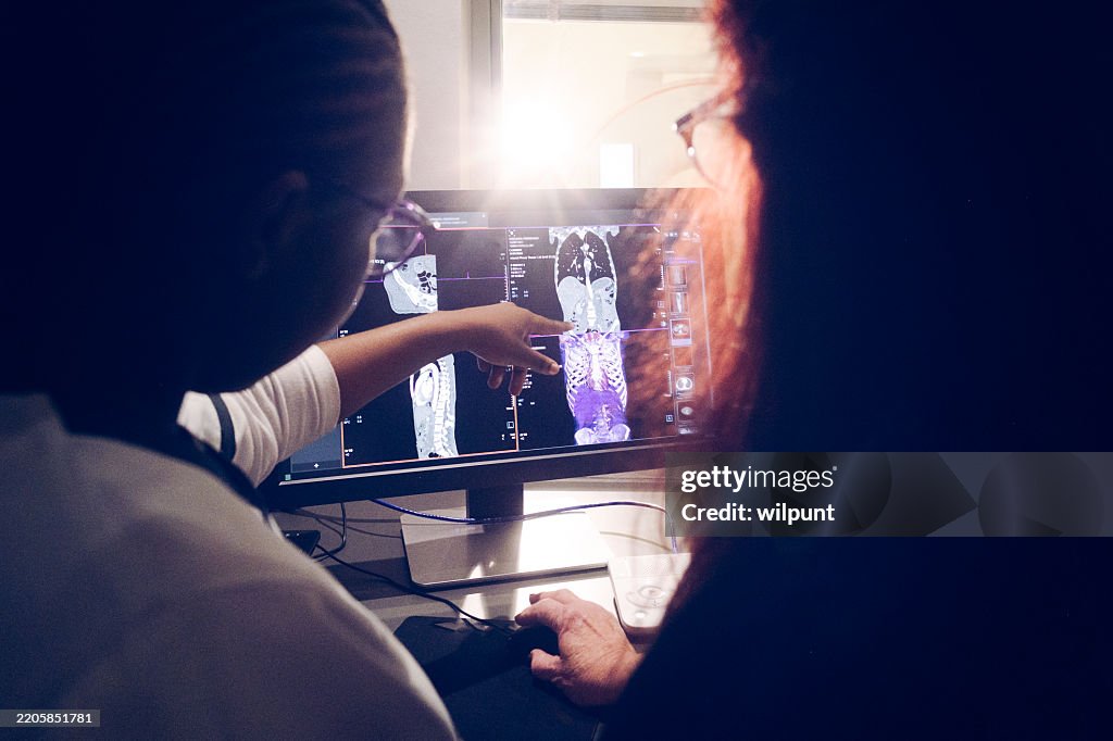 Doctors Analyzing Medical Imaging on Computer Screen for Diagnosis