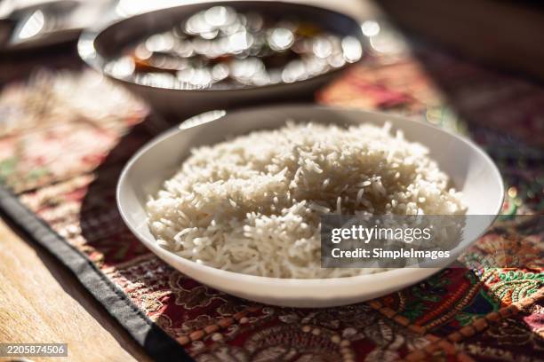 boiled basmati rice as a side dish on a table in a restaurant - carbohidrato fotografías e imágenes de stock