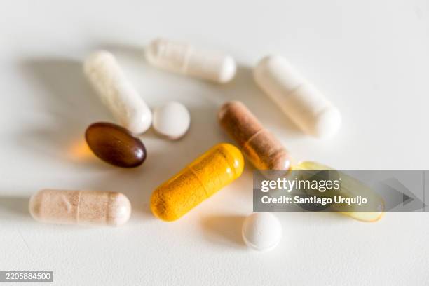 close-up of mineral, omega-3, turmeric, oregano oil and lactoferrin capsules - selenium stock pictures, royalty-free photos & images