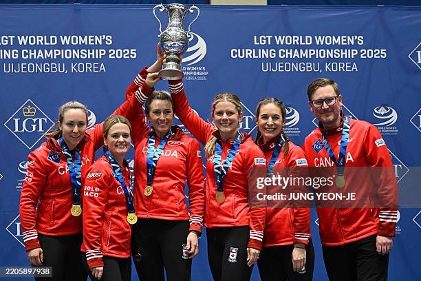 Gold medallists Canada's Rachel Homan, Tracy Fleury, Emma Miskew, Sarah Wilkes, Rachel Brown and coach Viktor Kjell pose during the award ceremony...