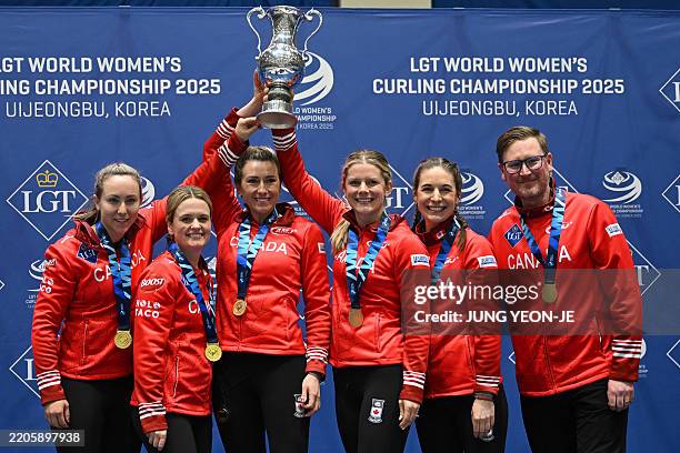 Gold medallists Canada's Rachel Homan, Tracy Fleury, Emma Miskew, Sarah Wilkes, Rachel Brown and coach Viktor Kjell pose during the award ceremony...