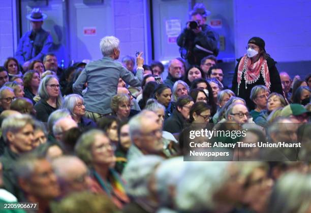 People argue with each other as U.S. Representative Paul Tonko holds a town hall meeting at Schenectady High School to listen to his constituents'...