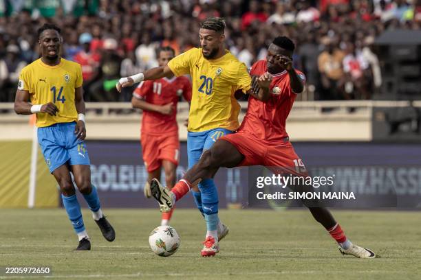 Gabon's Denis Bouanga vies for the ball with Kenya's Rooney Onyango during the FIFA World Cup 2026 Africa qualifiers group F football match between...