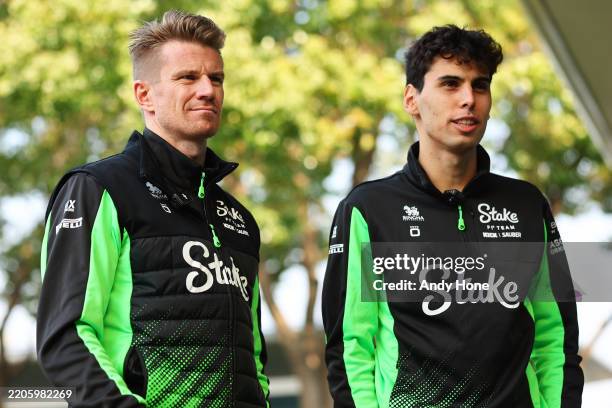 Nico Hulkenberg of Germany and Stake F1 Team Kick Sauber and Gabriel Bortoleto of Brazil and Stake F1 Team Kick Sauber looks on in the Paddock during...