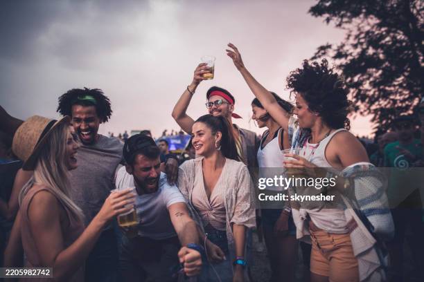 large group of cheerful friends dancing on an outdoor party. - festival tradicional imagens e fotografias de stock