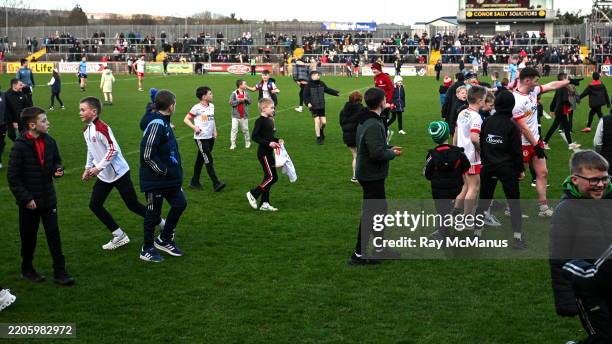 Tyrone , United Kingdom - 23 March 2025; Children run on the pitch after the hooter went thinking the game was over during the Allianz Football...