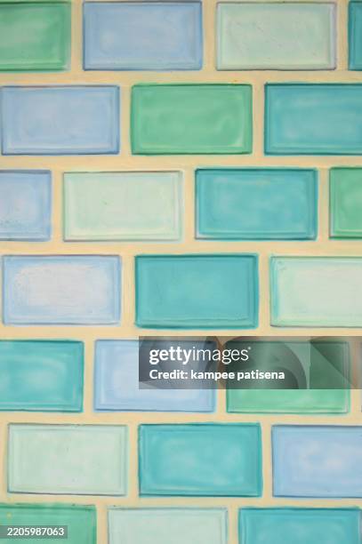a wall made of blue and green tiles - dirty shower room stock pictures, royalty-free photos & images