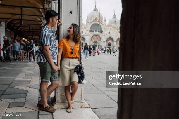 couple in love visiting venice - italy - st marks square stock pictures, royalty-free photos & images