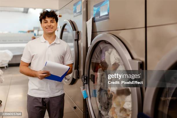 small business goals: laundry service owner - launderette stock pictures, royalty-free photos & images