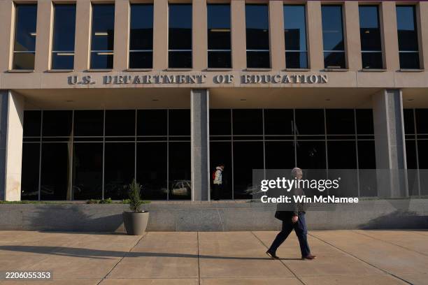 Person walks past the U.S. Department of Education on March 20, 2025 in Washington, DC. U.S. President Donald Trump is preparing to sign an executive...