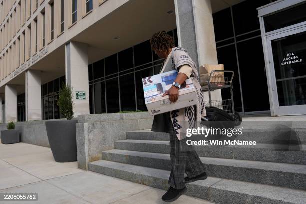 Department of Education employee leaves the building with their belonging on March 20, 2025 in Washington, DC. U.S. President Donald Trump is...