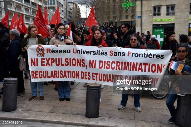 Protesters hold a banner saying "no expulsions, no discrimination" and "regularization of undocumented students" during the rally. On the occasion of...