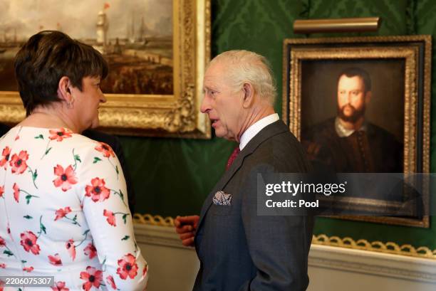 King Charles III speaks with Co-operation Ireland director Arlene Foster at a Future Leaders Event at Hillsborough Castle in Hillsborough during an...
