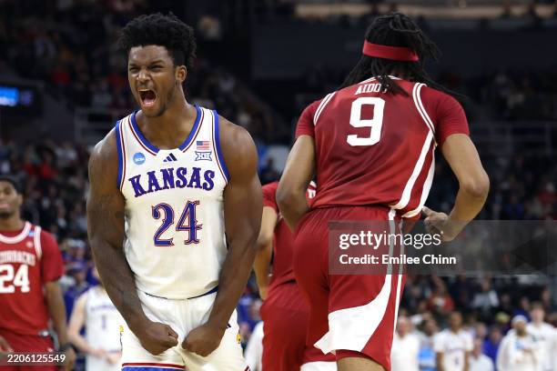 Adams Jr. #24 of the Kansas Jayhawks celebrates after a dunk by Flory Bidunga during the first half in the first round of the NCAA Men's Basketball...