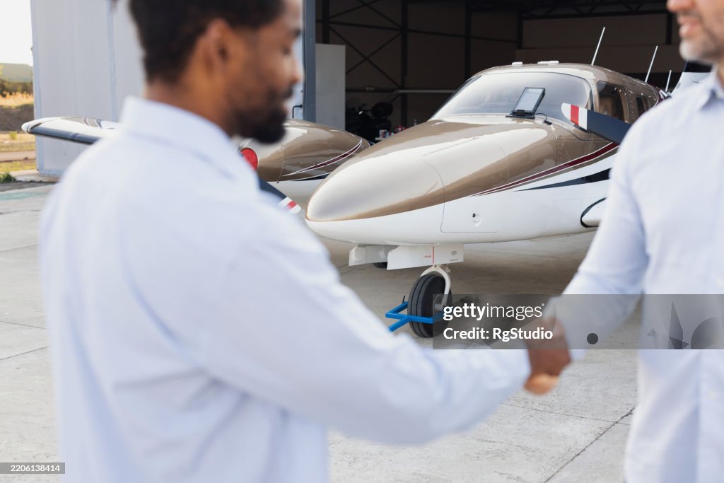 Business partners making a deal at the small airport