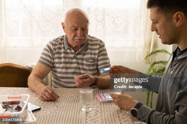 taking daily dose of pills - pill container stock pictures, royalty-free photos & images