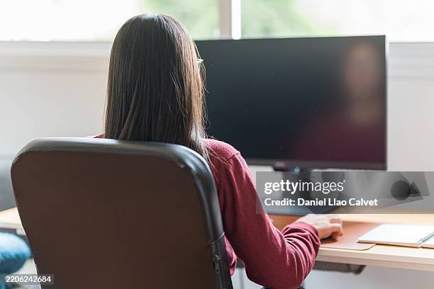 young woman working from home on desktop computer - using computer blank screen stock pictures, royalty-free photos & images