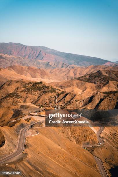 aerial view of distant highway in arid mountains - north africa stock pictures, royalty-free photos & images