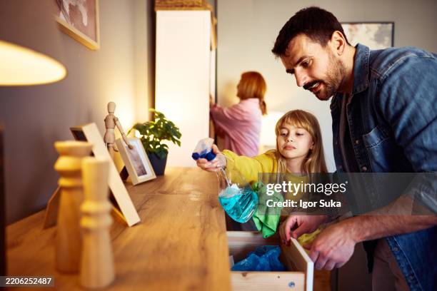 family cleaning and organizing wooden furniture together - drop cloth stock pictures, royalty-free photos & images