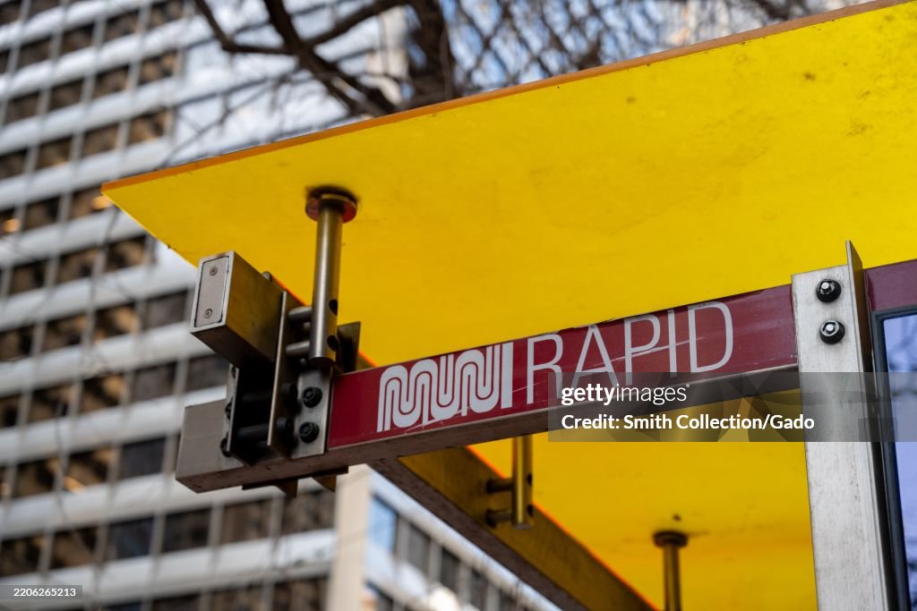 Muni Sign Close-up of a Muni Rapid bus stop sign beneath a bright yellow... News ...