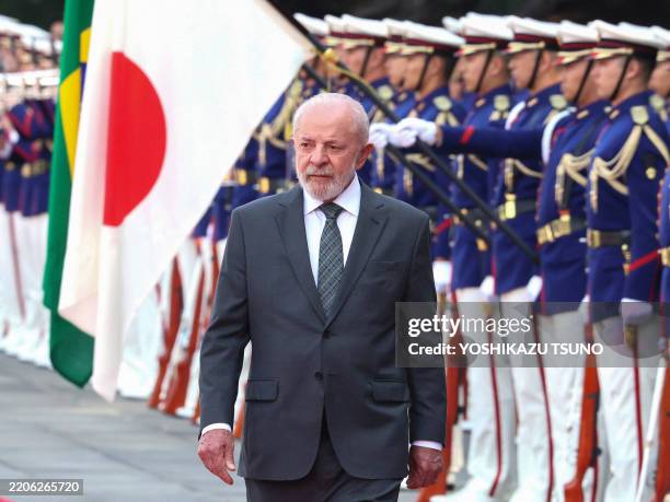 Brazil's President Luiz Inacio Lula da Silva reviews the honour guards during a welcoming ceremony at the Imperial Palace in Tokyo on March 25, 2025.