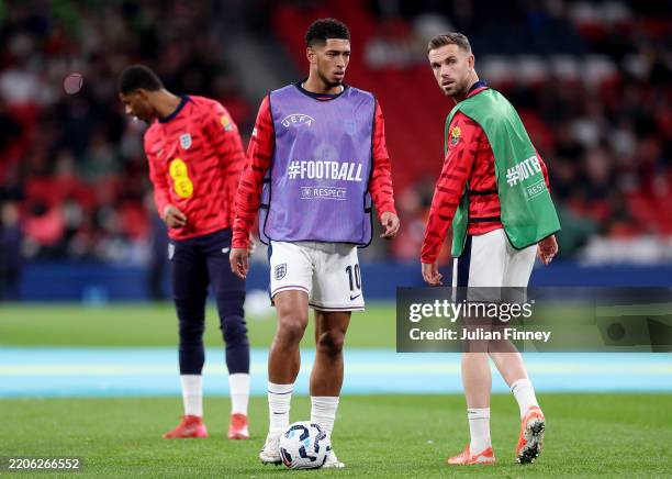 Jude Bellingham and Jordan Henderson of England look on as they warm up prior to the FIFA World Cup 2026 European Qualifier between England and...
