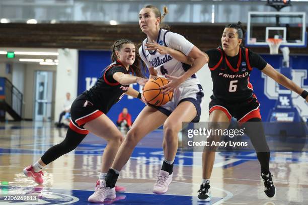 Serena Sundell of the Kansas State Wildcats tries to drive between Kaety L'Amoreaux and Izabela Nicoletti Leite of the Fairfield Stags during the...
