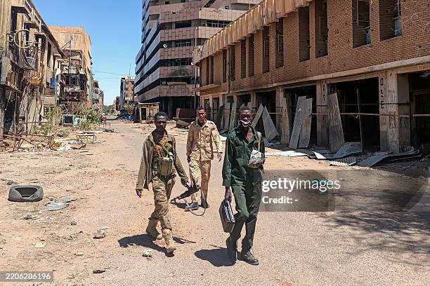 Fighters loyal to the army patrol a market area in Khartoum on March 24, 2025. For nearly two years, Sudan has been ravaged by a war between the...