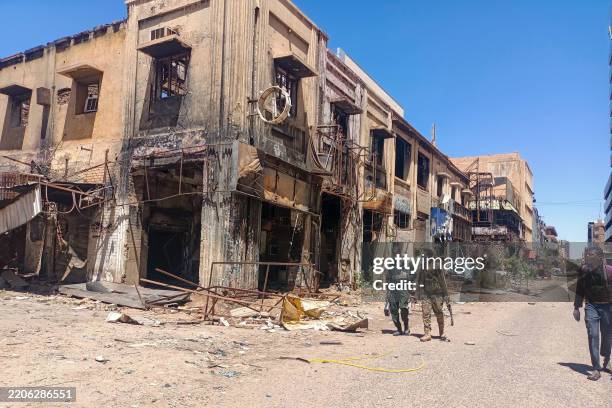 Fighters loyal to the army patrol a market area in Khartoum on March 24, 2025. For nearly two years, Sudan has been ravaged by a war between the...