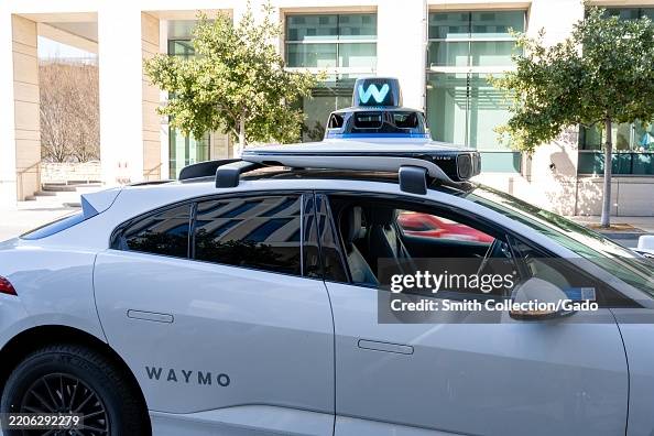 Waymo Sensor Array Self-driving Waymo car with rooftop sensor array stopped in front of ...