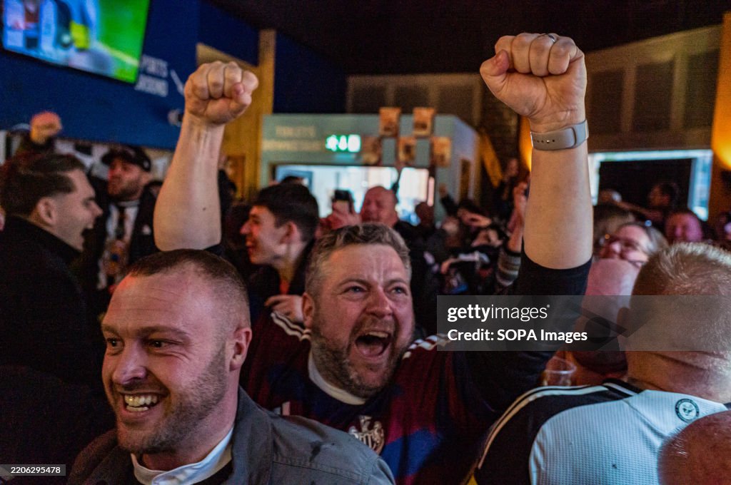 At a Marylebone sports bar, Newcastle United fans joyously...