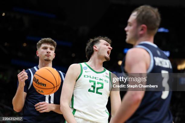 Nate Bittle of the Oregon Ducks celebrates after making a basket while being fouled as Zander Yates and Kaden Metheny of the Liberty Flames look on...