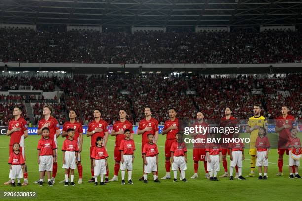Indonesia's team stands during the national anthem before the start of the World Cup 2026 Asian qualifier football match between Indonesia and...