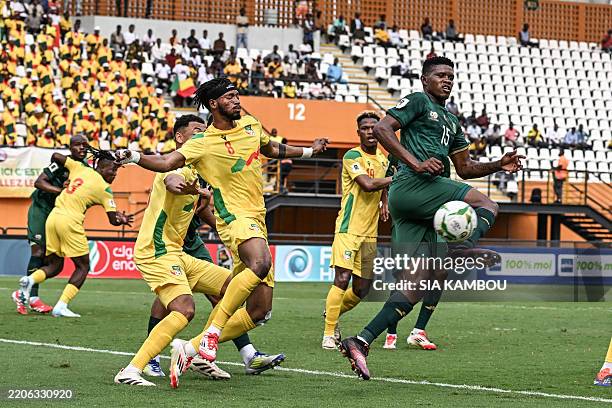 South Africa's midfielder Bathusi Aubaas controls the ball as he is marked by Benin's midfielder Hassane Imourane during the FIFA World Cup 2026...